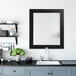 A BrandtWorks matte black finish mirror above a kitchen sink.
