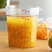 A large clear Cambro food storage container full of diced pineapples.