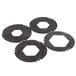 A group of four black circular rubber washers with a hexagon cut out.