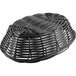 A Tablecraft black oval woven rattan bread basket on a table.