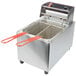 A Cecilware commercial electric countertop deep fryer with red handles and two baskets.