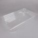 A Carlisle clear plastic food pan on a counter.