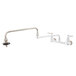 A silver T&S wall mounted pot filler faucet with knobs and a hose.