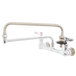 A T&S chrome wall-mounted pot filler faucet with a handle and hose.