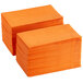 A stack of orange 2-ply paper dinner napkins.