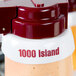 A white plastic Tablecraft salad dressing dispenser collar with maroon lettering on it.