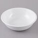 A white Carlisle melamine bowl on a gray surface.
