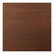 A close-up of a Perfect Tables dark walnut woodgrain table top.