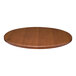 A close-up of a Perfect Tables 30" outdoor round cherry woodgrain table top.