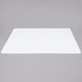 A white rectangular Tablecraft flexible cutting board on a gray surface.