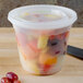 A Pactiv translucent plastic deli container filled with fruit.