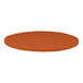 A close-up of a round brown table top with a textured surface in orange.