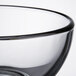 A close up of a clear Libbey glass bowl with a black rim.