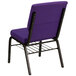 A purple Flash Furniture church chair with a gold metal frame and a book rack.