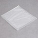 A clear ARY VacMaster vacuum packaging bag on a grey surface.