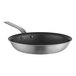 A close-up of a Vollrath stainless steel frying pan with a black interior.