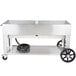 A large stainless steel Crown Verity outdoor BBQ grill with wheels.