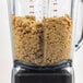 The Breville Commercial blender filled with brown food.