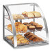 A Cal-Mil stainless steel bakery display case with pastries and muffins.