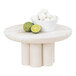 A Cal-Mil white-washed pine wood display riser on a table with a bowl of food and limes next to a lime.
