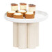 A Cal-Mil white-washed pine wood pedestal display riser with desserts on it.