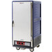 A large blue Metro C5 heated holding cabinet with a solid door on wheels.