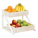 A Cal-Mil white-washed pine wood 2-tier display with fruit in wooden trays.