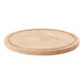 A round oak wood serving board with a circular edge.