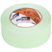 A close-up of a roll of Shurtape green painter's tape with the word "tape" on it.