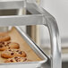A tray of cookies on a Regency end load sheet pan rack.