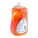 A bottle of Joy Ultra orange scented dishwashing liquid with a label.