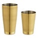 Two gold Barfly cocktail shakers with a diamond lattice pattern.
