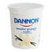 A white container of Dannon Non-Fat Vanilla Yogurt with a blue and white label and lid.