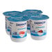 A group of Dannon Creamy Non-Fat Cherry and Raspberry Yogurt containers.