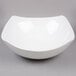 An American Metalcraft white square stoneware bowl on a gray surface.