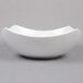 An American Metalcraft white stoneware bowl with a curved shape on a gray background.
