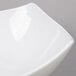 A close-up of an American Metalcraft white square stoneware bowl.