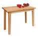 A John Boos natural maple wood work table with a bowl of apples and a bowl of sauce.