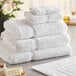 A stack of white Lavex Premium bath mats.