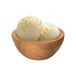 A scoop of G.S. Gelato plant-based Indonesian vanilla bean coconut milk frozen dessert in a wooden bowl.