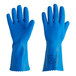 A close-up of a hand wearing a blue Ansell AlphaTec rubber glove with a crinkle finish.