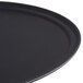 A black oval Carlisle non-skid fiberglass serving tray.