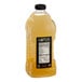 A bottle of Lotus Plant Energy Lemonade Concentrate with a yellow label and liquid.