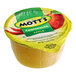 A close-up of a yellow Mott's applesauce cup with a green label.