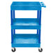 A blue plastic utility cart with three shelves and wheels.