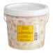 A white plastic container of Sevillo Fine Foods Slow Roasted Yellow Tomatoes.