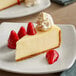 A slice of Classic Cheesecake with strawberries and whipped cream on a plate.