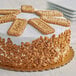 A cake with Lotus Biscoff crumb topping on a white plate.