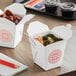 Two Emperor's Select Asian take-out containers with food inside.
