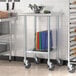 A Steelton stainless steel work table with an undershelf and casters holding a basket of food.